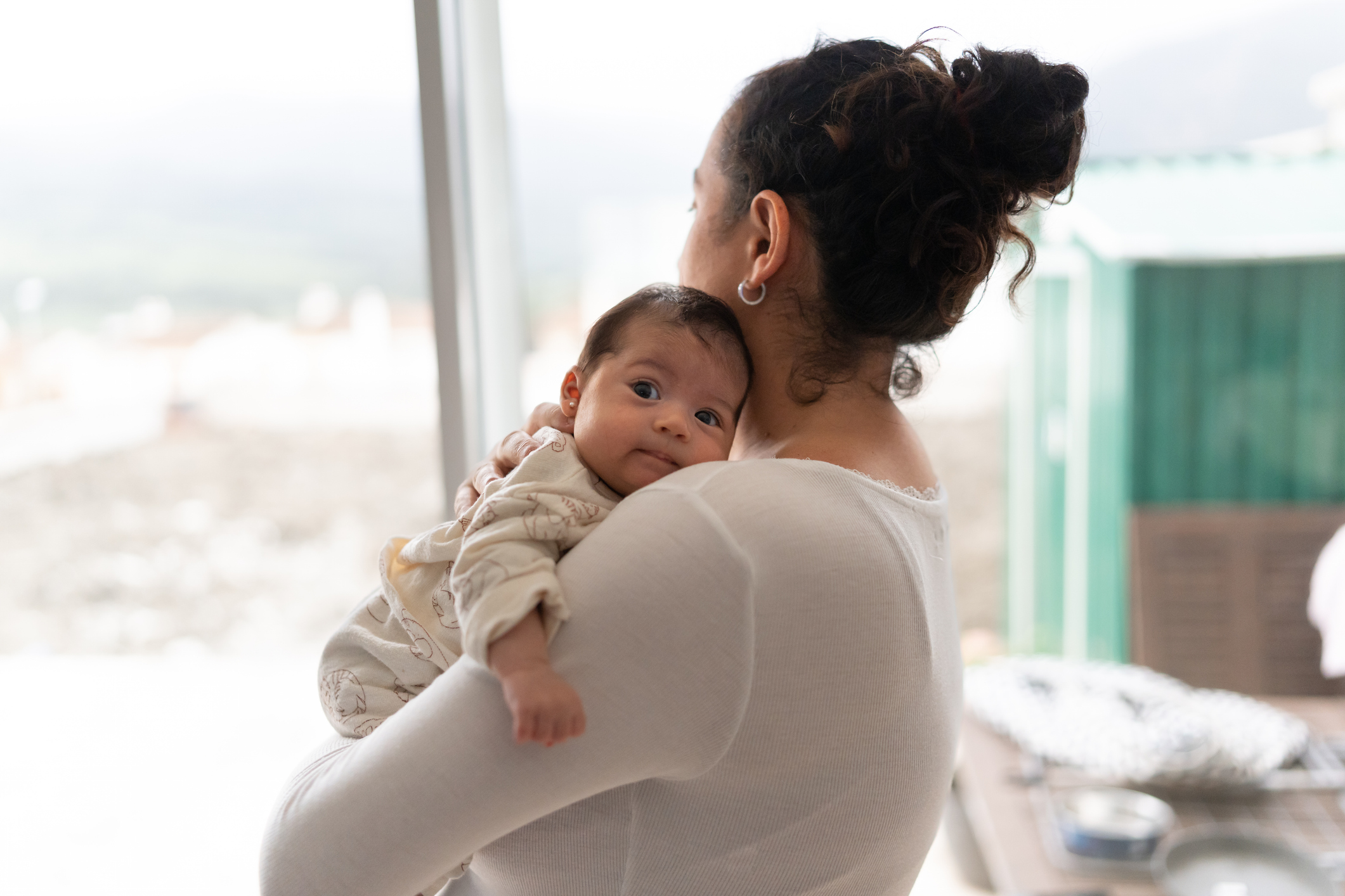 Photo shows a mother holding her baby in her arms/Getty Images