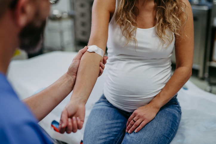 Photo shows a doctor taking a blood sample from a pregnant woman/Getty Images