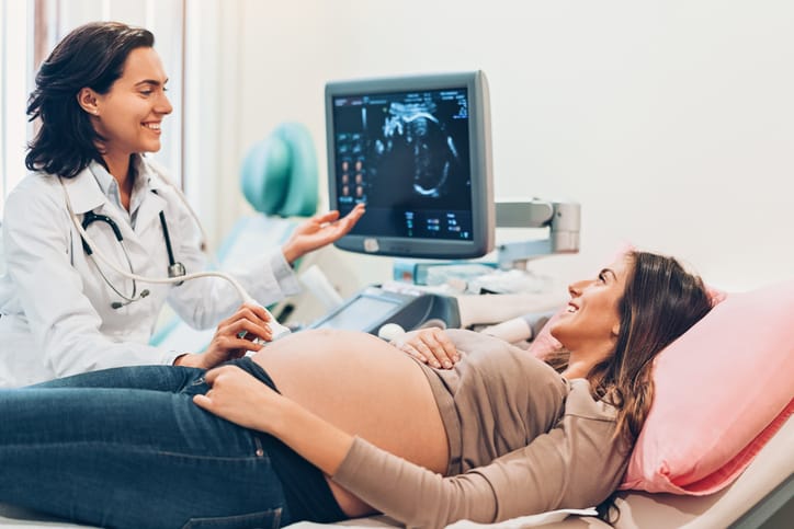 Photo shows a pregnant woman watching her baby during an ultrasound/Getty Images