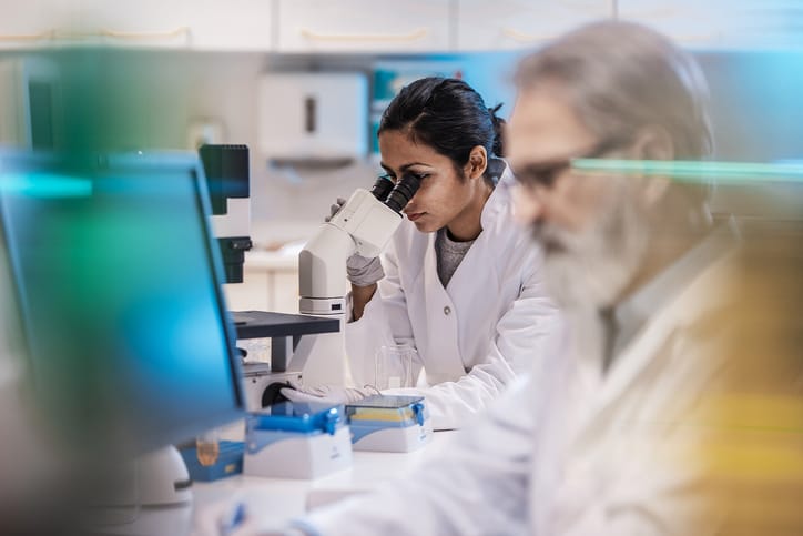 Photo shows scientists working together in a lab/Getty Images