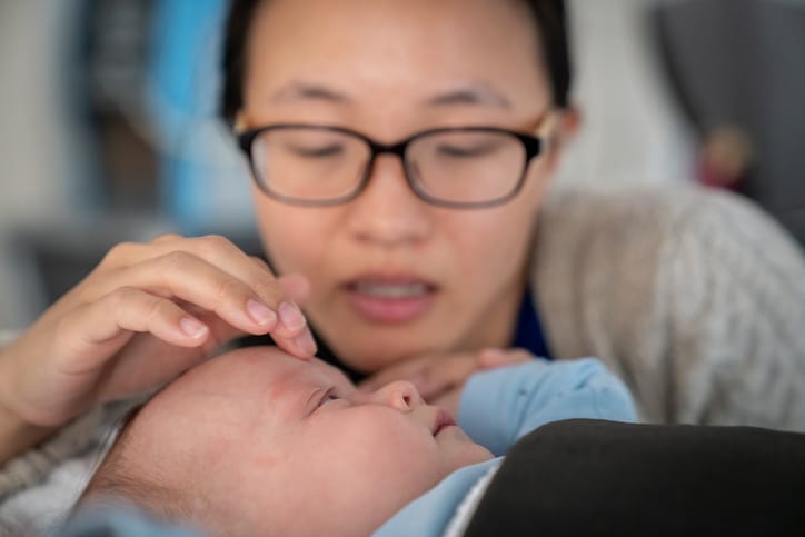 Photo shows a mom caring for her baby during an MRI scan/Getty Images