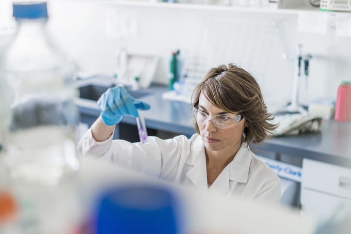 Photo shows a chemist examining a chemical in a test tube/Getty Images