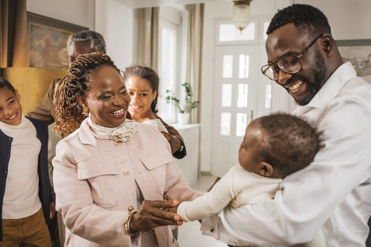 Photo shows a family meeting a new baby for the first time/Getty Images