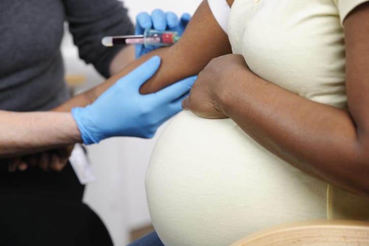 Photo shows a close-up view of a pregnant woman having blood drawn/Getty Images