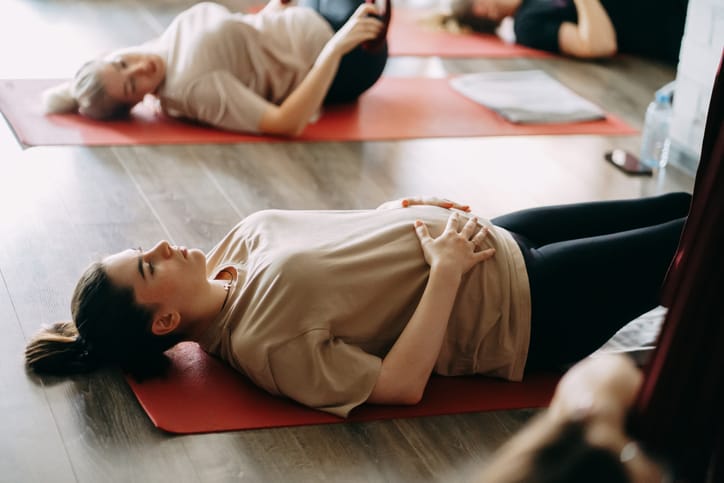 Photo shows two pregnant woman taking a yoga class/Getty Images