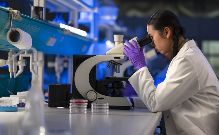 Photo shows a young scientist working in a laboratory/Getty Images