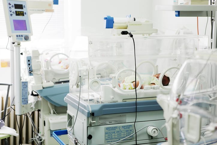 Photo shows newborns in a row in a NICU/Getty Images