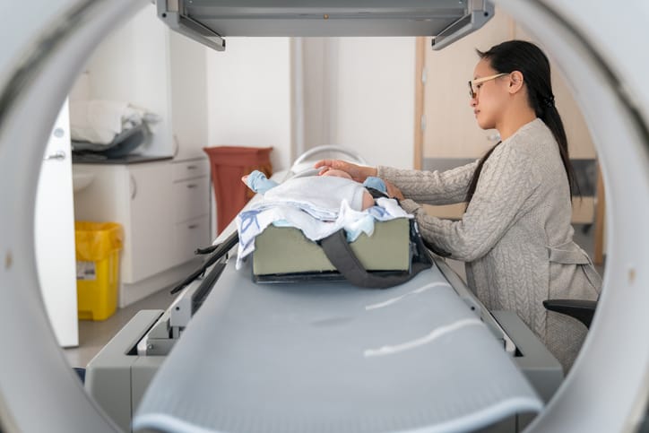Photo shows a mom keeping her daughter calm during her MRI/Getty Images/Morten Falch Sortland