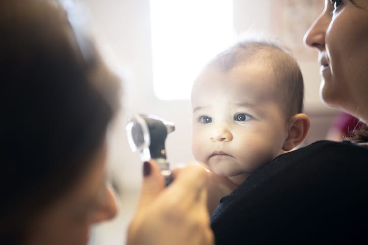 Photo shows a doctor examining a baby's eyes (Getty Images/isayildiz)